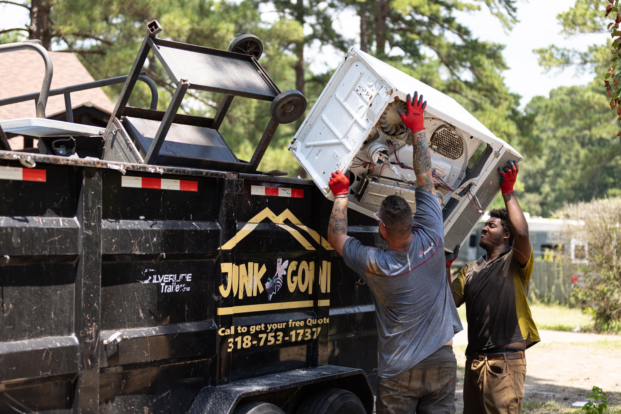 Junk Bee Gone team posing in front of a truck